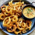 Friterede løgringe - hjemmelavede indbagte løg serveret med cheddar dip