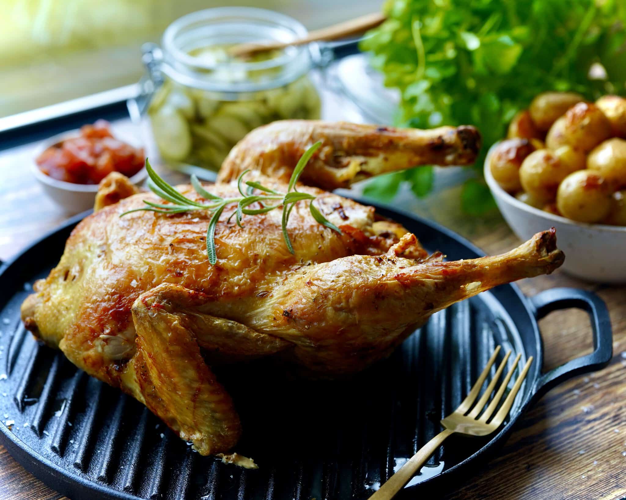 Helstegt kylling i airfryer serveret med stegte kartofler og agurkesalat